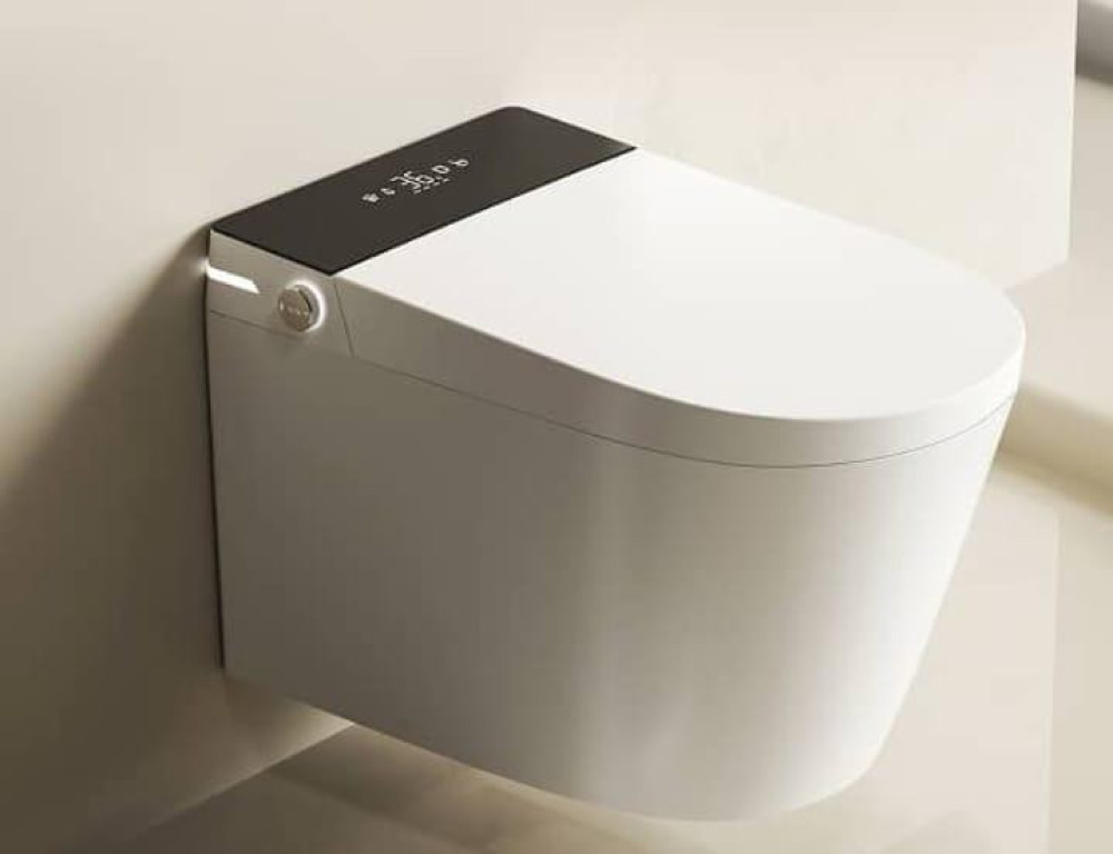Modern, wall-mounted smart toilet featuring a built-in bidet and a sleek black digital control panel