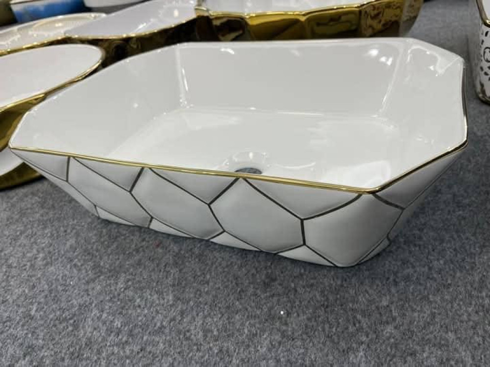 This is a bassino Art Series table top wash with a white and gold geometric design