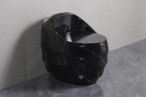 Black marble toilet featuring a sleek, one-piece design with a bold marble finish and white veining