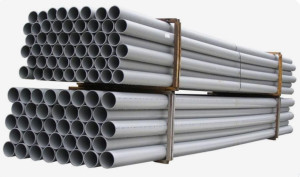 bundles of grey PVC pipes typically used in construction and plumbing