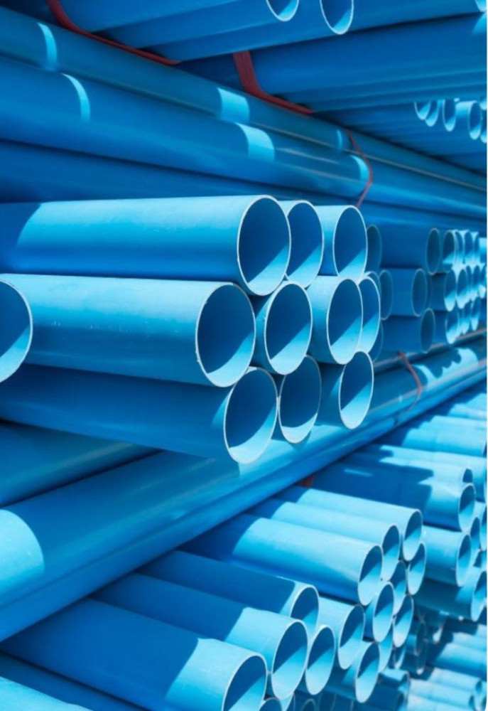 large stack of blue PVC pipes cmmonly used for construction