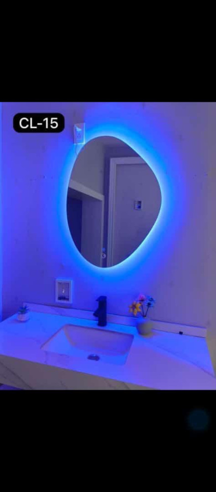 Contmporary-style irregular or oval-shaped LED bathroom vanity mirror designed for wall mounting