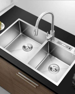 double-bowl stainless steel kitchn sink featuring  a pull-out faucet and modern, small radius corners
