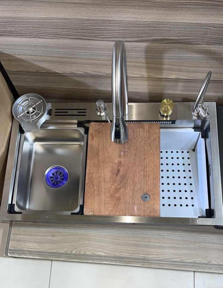multifucntional stainless stee Kitchen workstation sink that typically includes accessories like cutting board, drain basket, and waterfall faucet