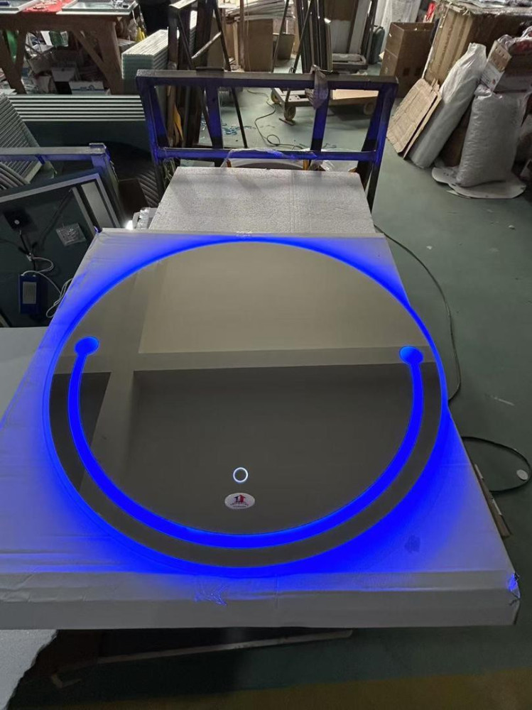 round LED bathroom wall mirror with a touch sensor button for control