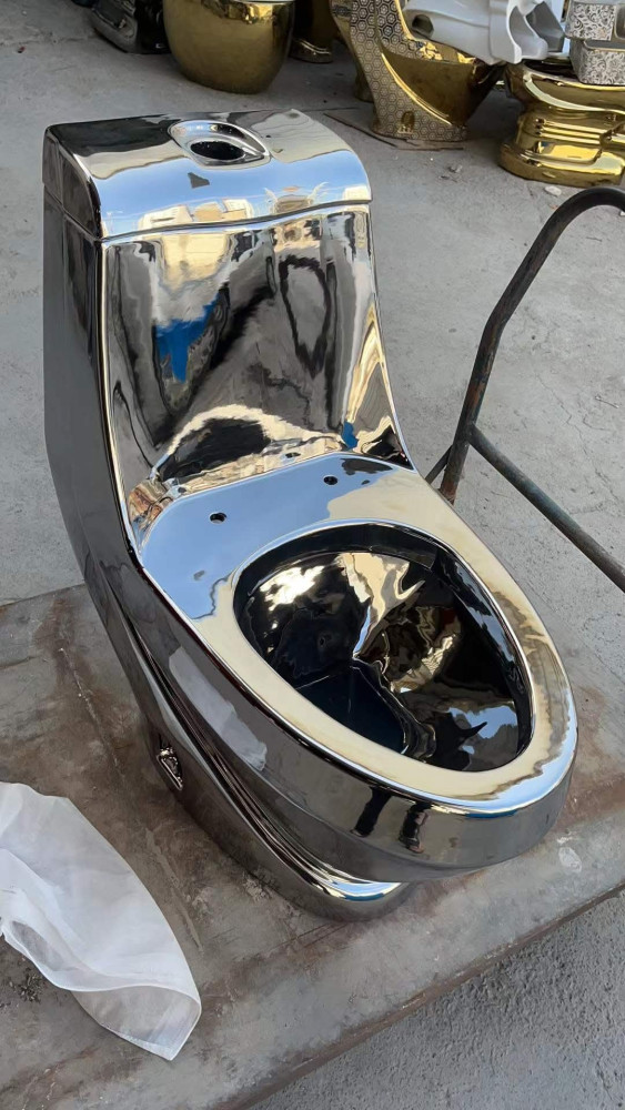 modern luxury one-piece ceramic toilet with a polished chrome or sliver electroplated finish