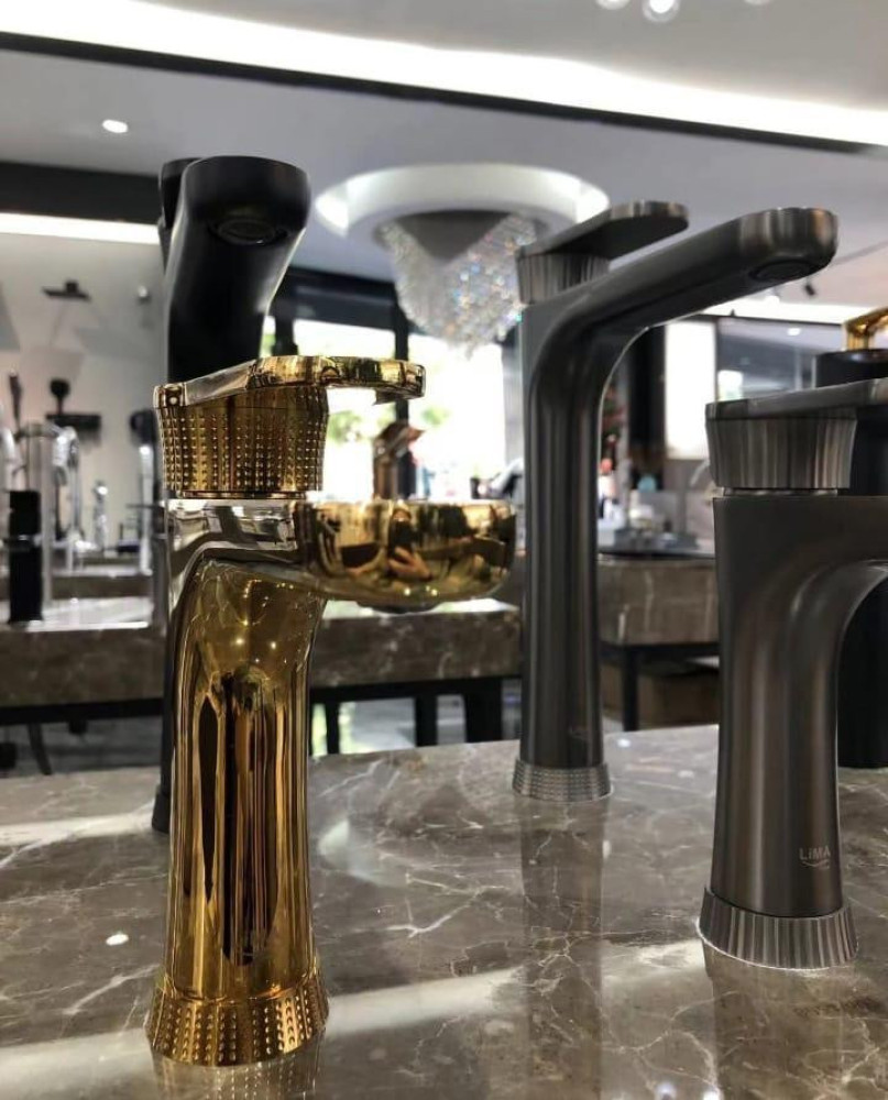 features a collection of modern bathroom sink faucets in black and plished gold finishes