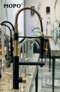 modern spring-type Kitchen faucet featuring a matte black finish with gold accents