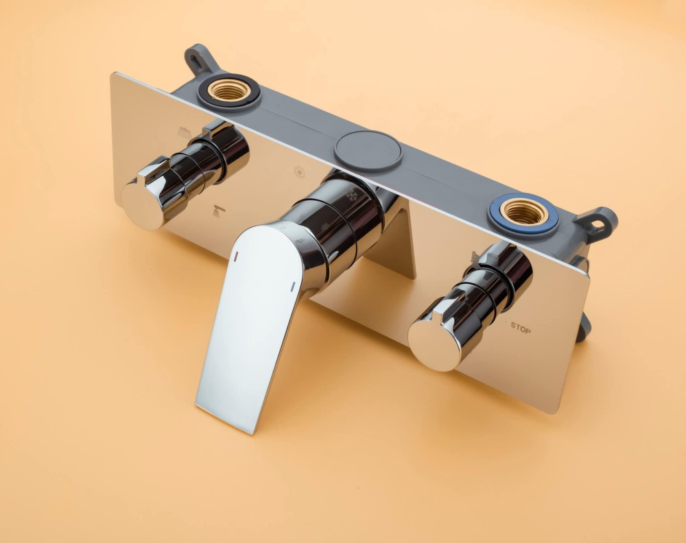 3-way thermostatic shower mixer with three inlets and outlets typically used in modern bathrooms for controlling water flow and temperature