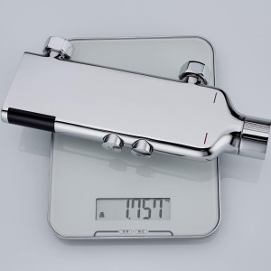 chrome-plated thermostatic shower mixing valve beng weighed on a digital scale