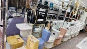 showroom display of various modern bathroom fixtures and sanitary ware, including water closets(toilet), wash hand basins, and decorative mirrors