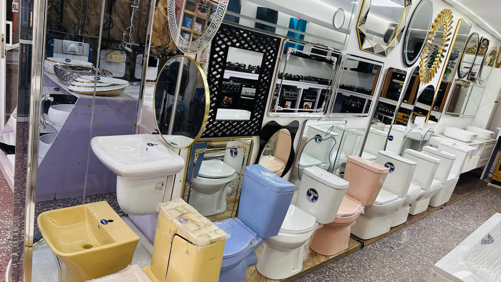 showroom display of various modern bathroom fixtures and sanitary ware, including water closets(toilet), wash hand basins, and decorative mirrors