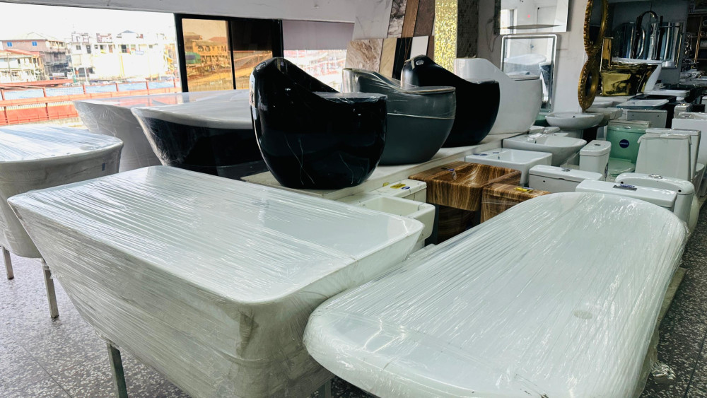 modern sanitary ware, including black and white freestanding soaking bathtubs and ceramic washbasins