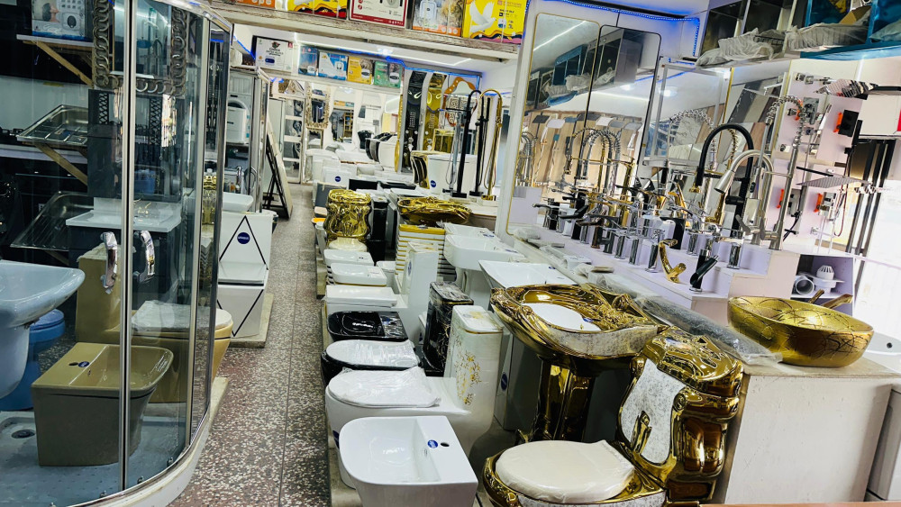 Showroom filled with various sanitary wares and bathroom fixtures, including toilets, washbasins, faucets, and showerheads